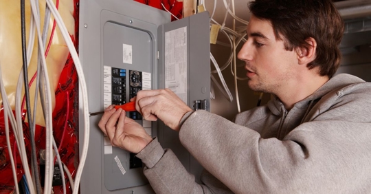 man working on electrical panel